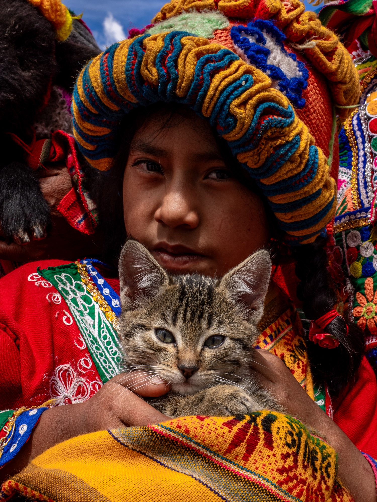 Fleeting Bonds — a child and a cat, from a series photographed across Asia, Africa, Europe and Latin America